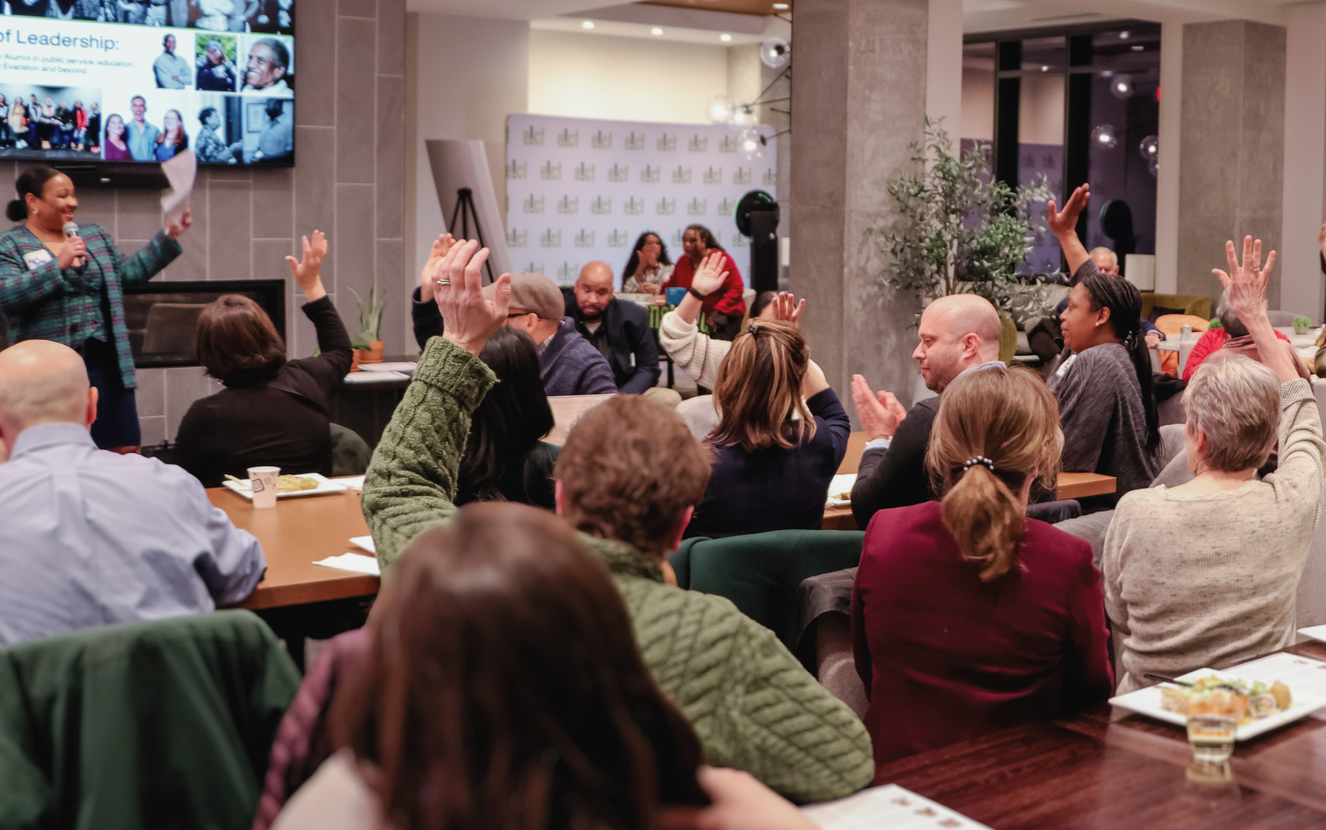 a group of people raising their hands